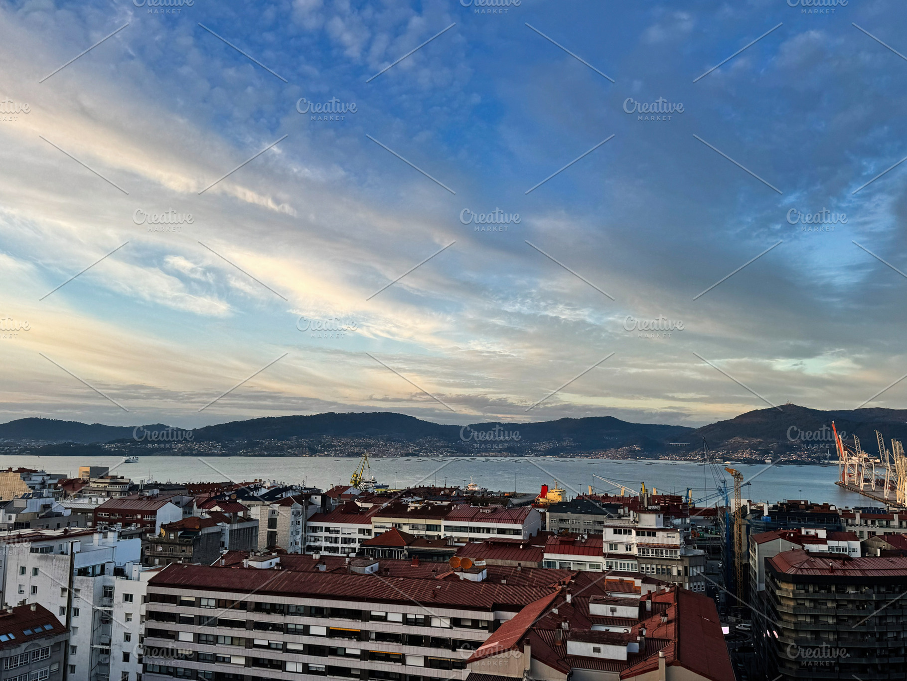 Panoramic view of Vigo city skyline with bay and surrounding hills under a vivi, a Photo by AS photostudio