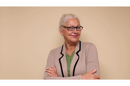 An elderly European woman in glasses