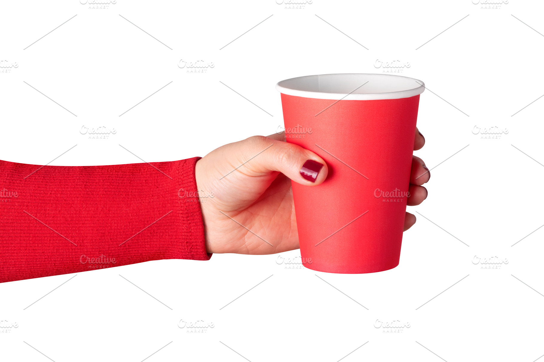 Close-up of a female hand holding a red paper cup on a white bac, a Food & Drink Photo by Ales Munt