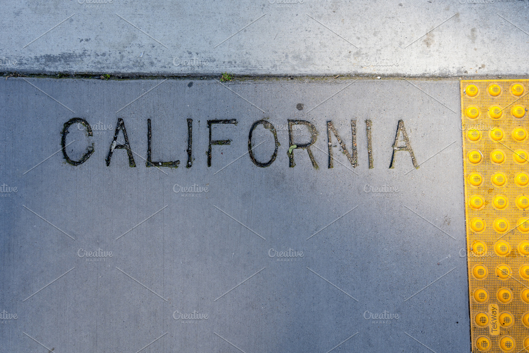 Engraved California text on a concrete sidewalk in San Francis, an Architecture Photo by GoodGoods