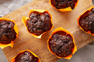 Homemade Chocolate Chip Muffins on a wooden board, top view., a Food & Drink Photo by LiudmylaChuhunova