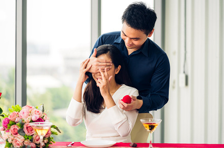 Young handsome man giving ring for surprise to girlfriend and ta, a Person Photo by Art_Photo