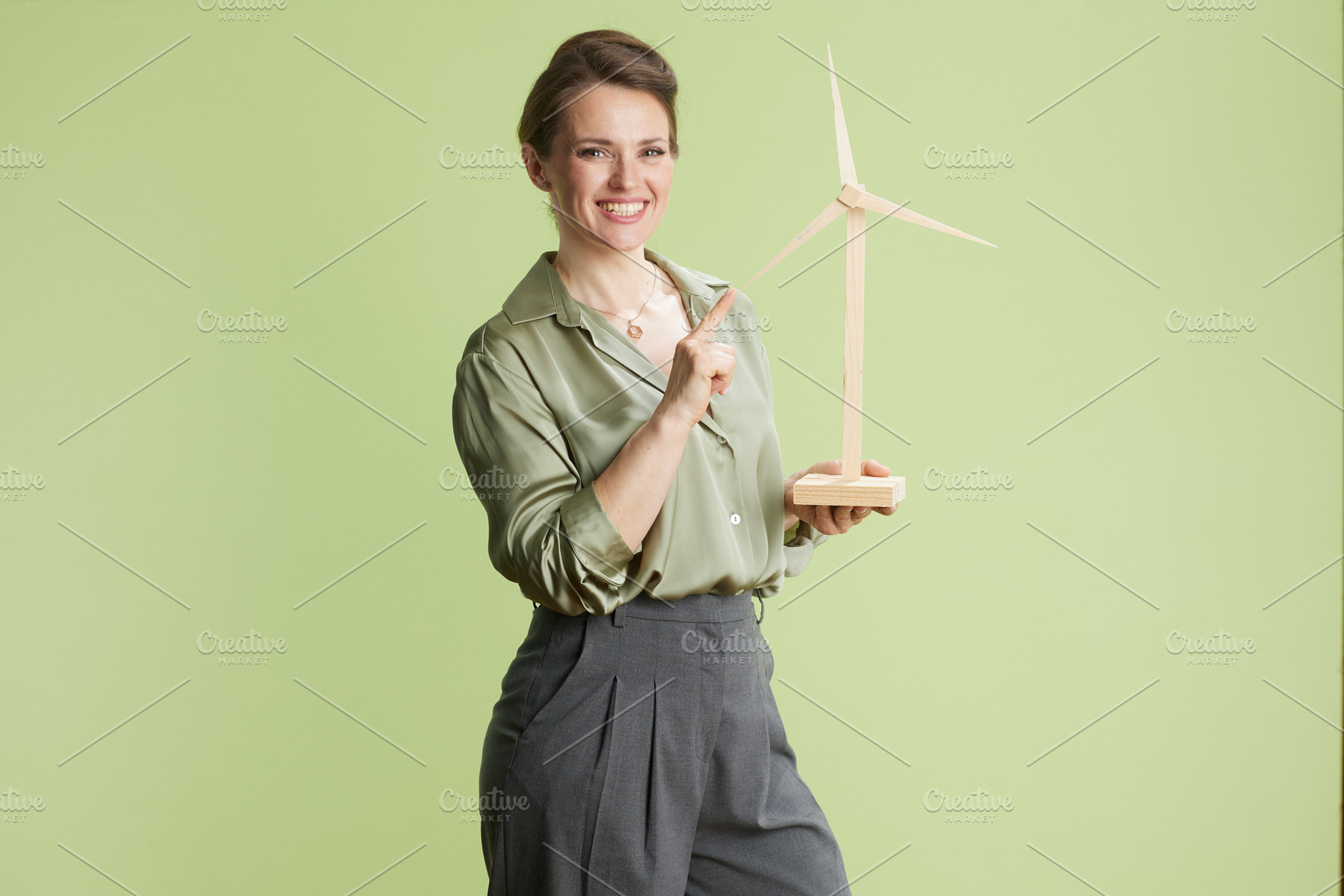 Enthusiastic woman promoting wind energy, a Business Photo by Alliance Images