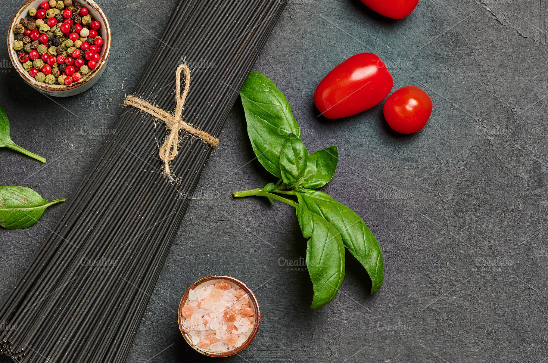 Black spaghetti, sprig of fresh basil, cherry tomatoes, pepper m, a Food & Drink Photo by ndanko