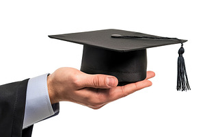 Black graduation cap in male hand on white background, a Photo by AlyaAnd