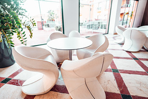 Modern cafe seating with glass view, an Architecture Photo by SkyNext