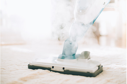 Cleaning the floor with steam