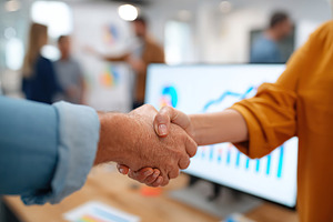 Handshake signifies partnership and growth between startup CEO and investor in, a Photo by AlyaAnd