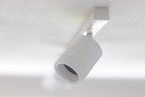 White cylindrical ceiling light illuminating a textured ceiling, an Architecture Photo by Antonio Gravante Market