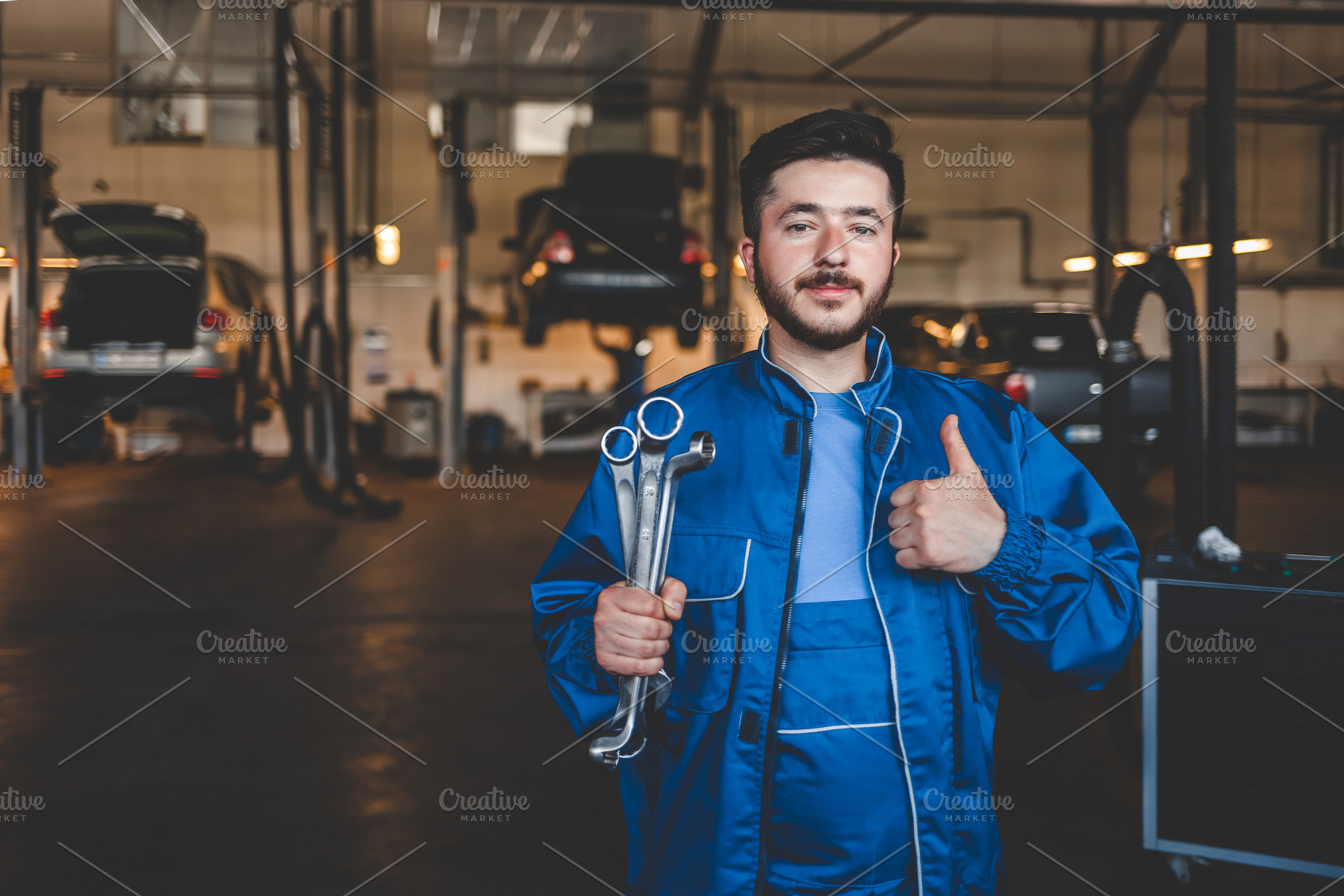 Car mechanic with wrench shows thumb, a Photo by Andrii Borodai