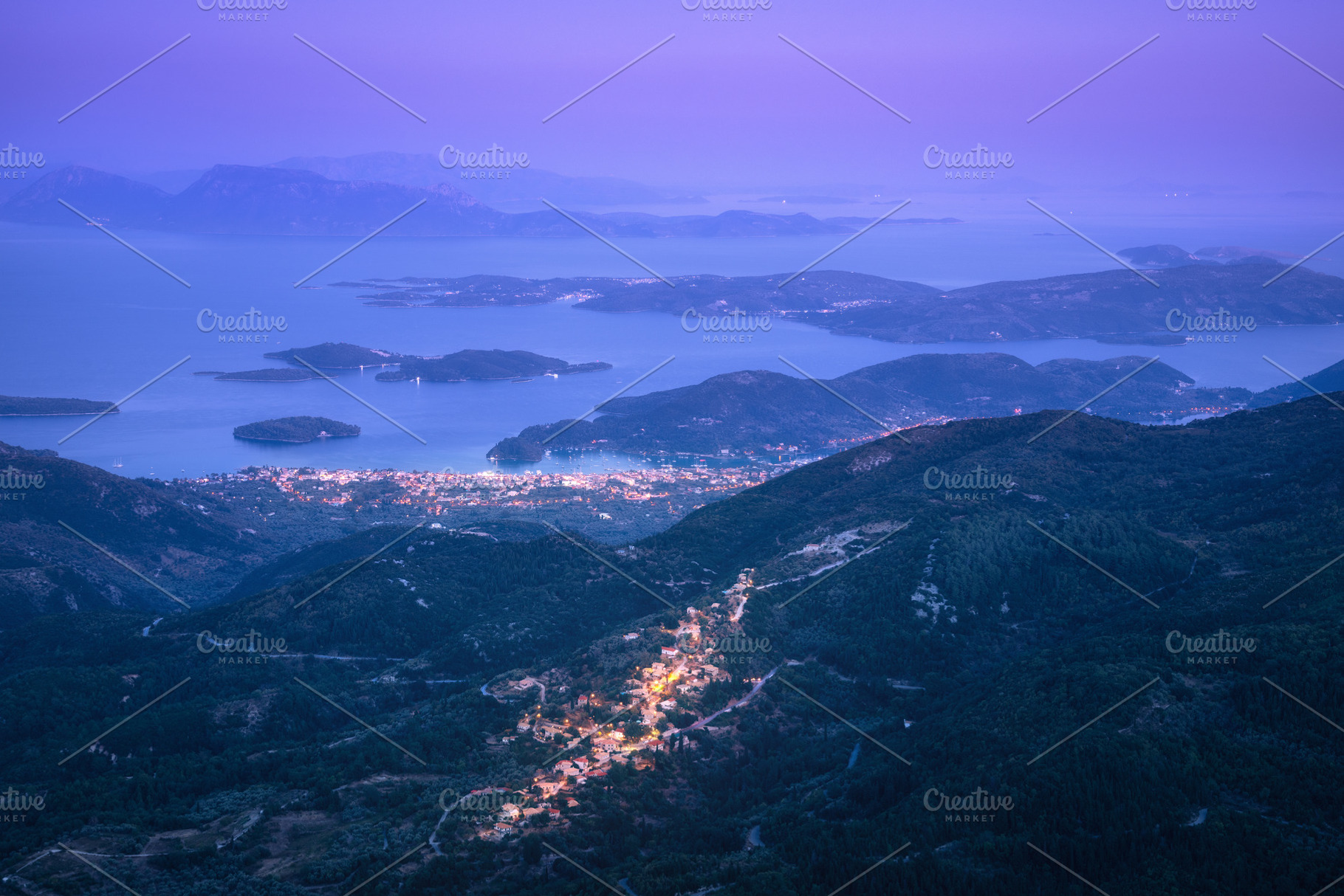 Small village in the mountain and city on the sea cost at night, a Nature Photo by den-belitsky