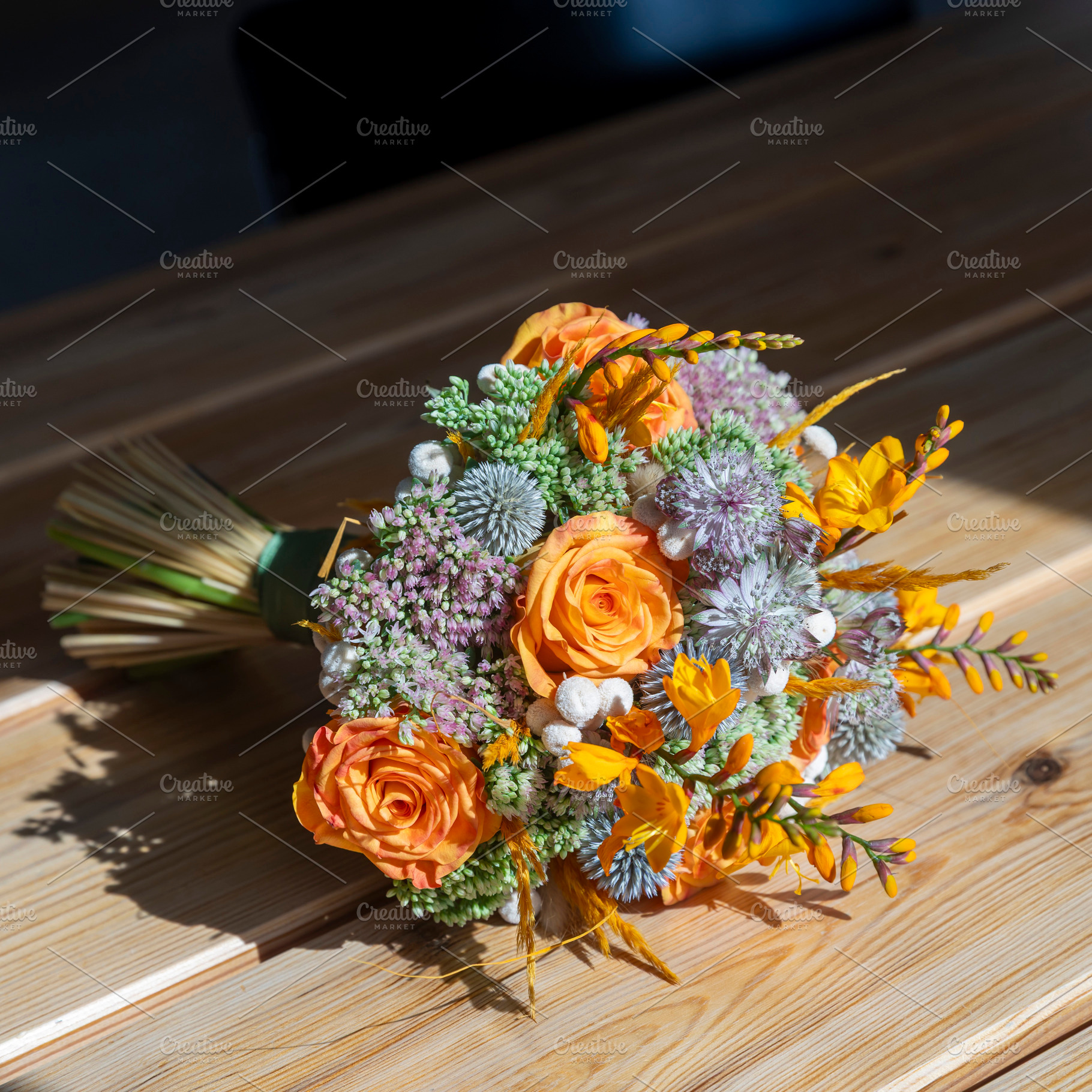 Close-up of a floral wedding bouquet featuring bright orange ros, an Architecture Photo by Imaginarium