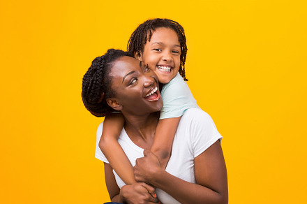 Black daughter embracing her happy c, a Background Photo by Prostock-Studio