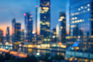 City skyline at dusk with lights, a Photo by Beautiful things