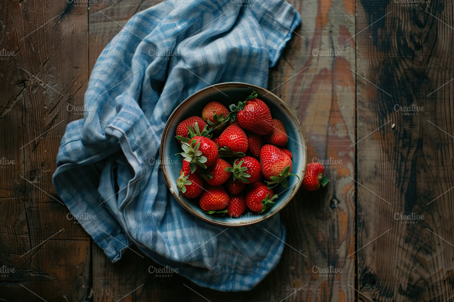Flat lay of red strawberries in bowl with napkin on wooden table, a Food & Drink Photo by AlyaAnd