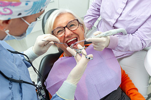 Dentists performing dental procedure on senior woman in clinic, a Health & Medical Photo by Antonio Gravante Market