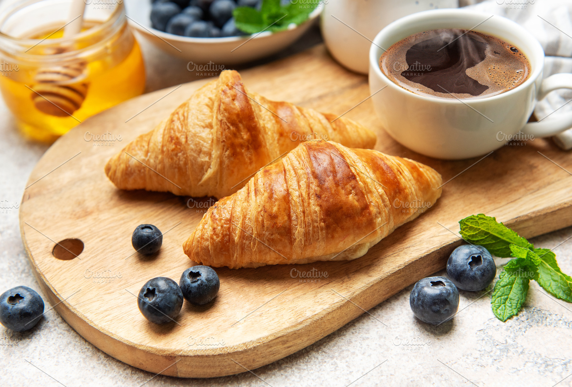 Delicious french croissants with coffee, honey and fresh blueber, a Food & Drink Photo by Olena Rudo