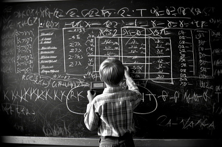 Photo of a child drawing a chalkboard full of complex mathematic, a School & Education Photo by designvectx