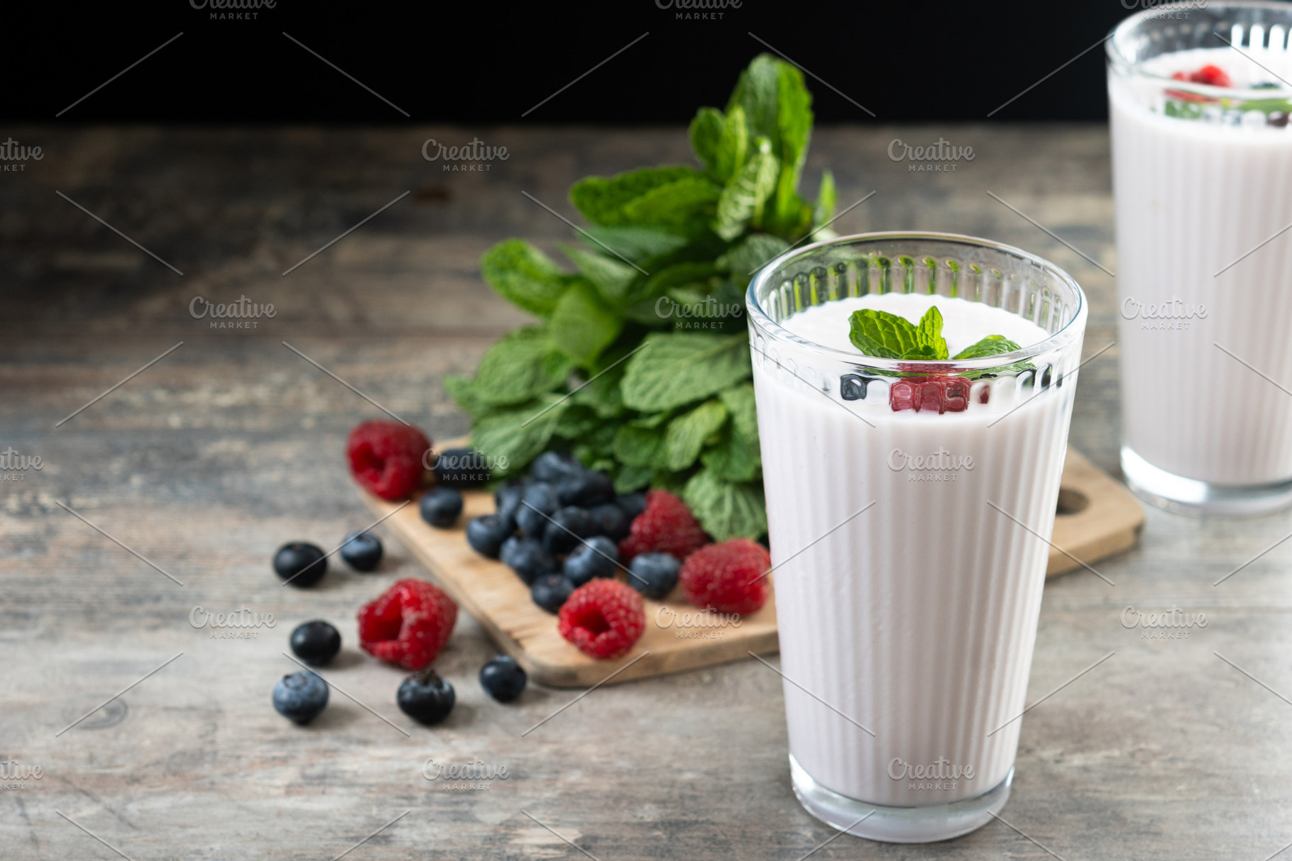 Fresh raspberry and blueberry smoothie on wooden table, a Food & Drink Photo by etorres69