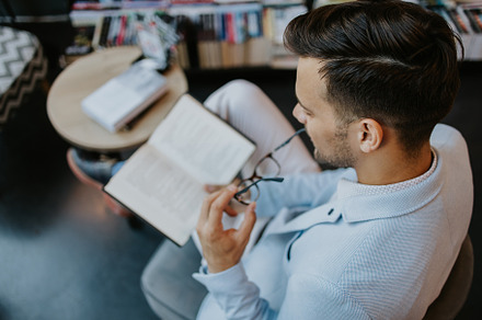 Young man in library, a School & Education Photo by REDDOT Studio