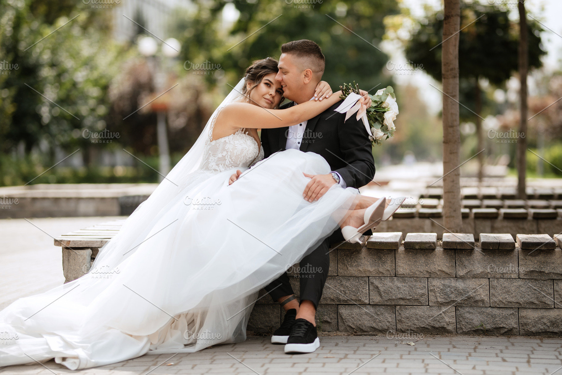 the groom in a brown suit and the bride in a white dress, a Person Photo by Weddings, People, Travel