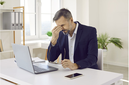 Mature man sitting at his office, a Business Photo by StudioRomantic