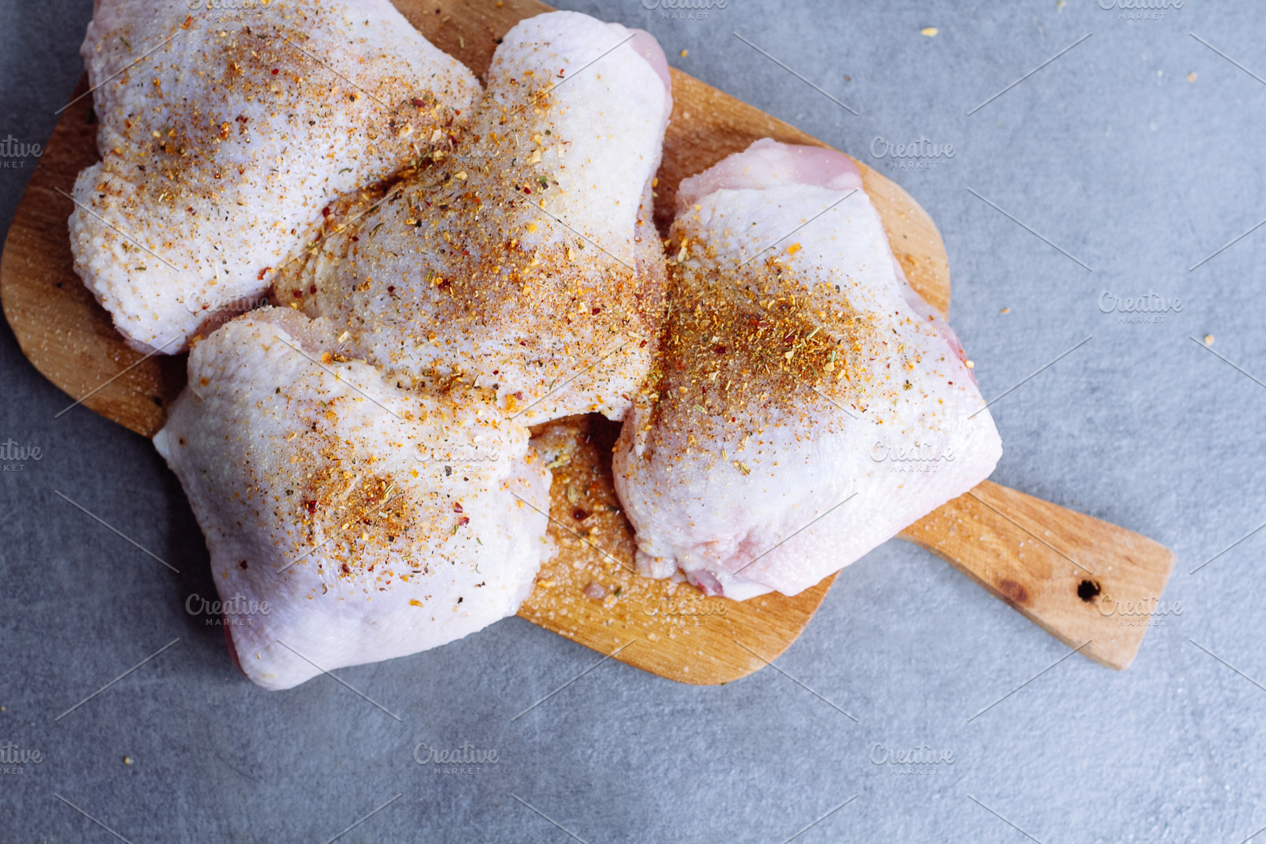 Raw chicken thigh with herbs featuring background, bird, and board, a Food & Drink Photo by telnyaw