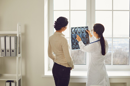 Doctor woman with xray talking containing woman, doctor, and x-ray, a Health & Medical Photo by StudioRomantic