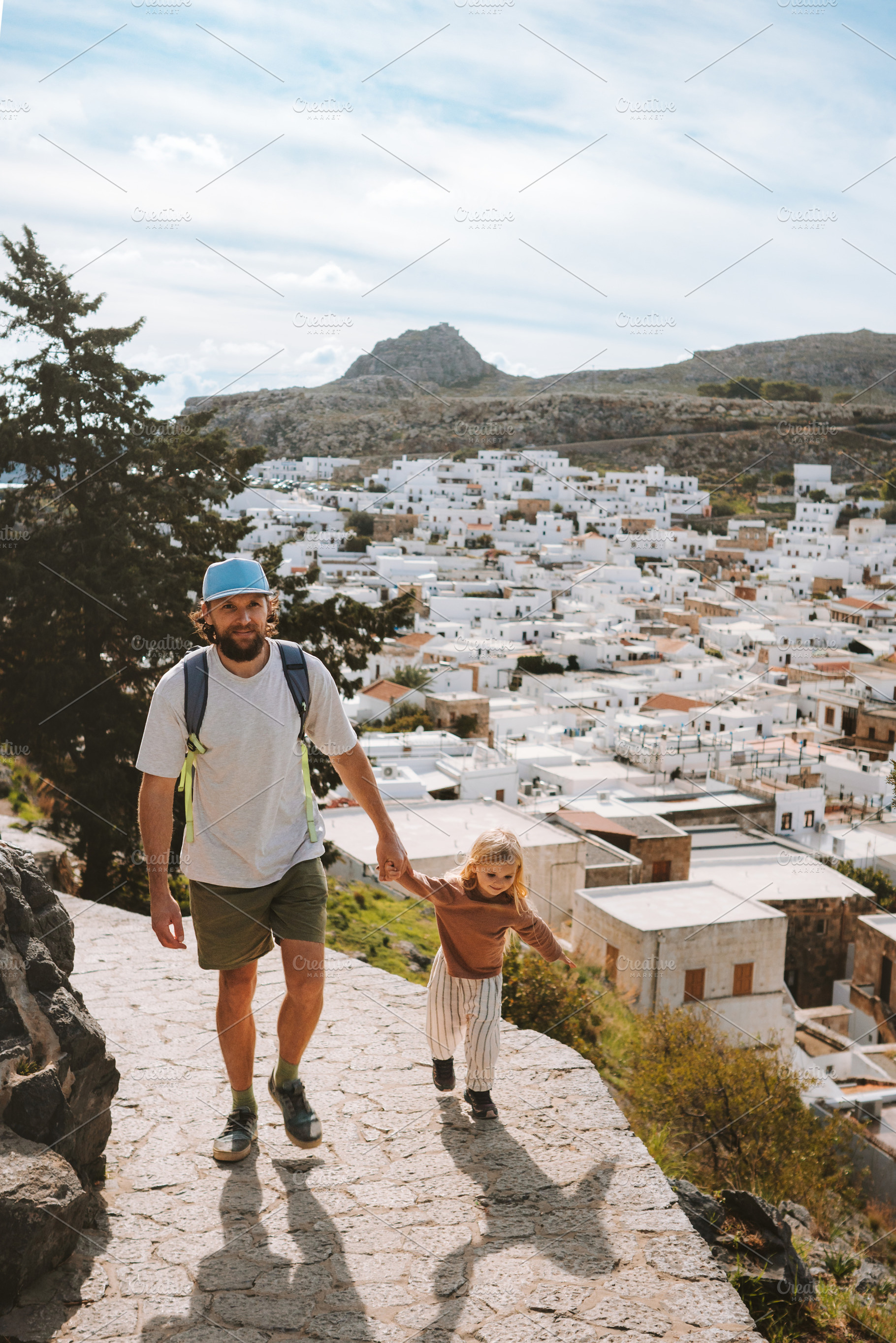 Father and child walking in Lindos city family travel in Rhodes island, Greece, a Person Photo by e v e r s t