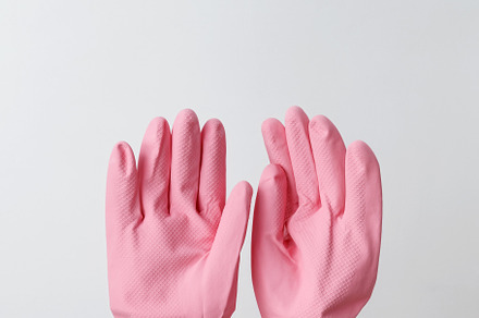 Female hands in pink rubber gloves doing house cleaning tasks. Household cleani