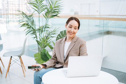 Young adult woman using laptop, a Business Photo by Galina_Zhigalova