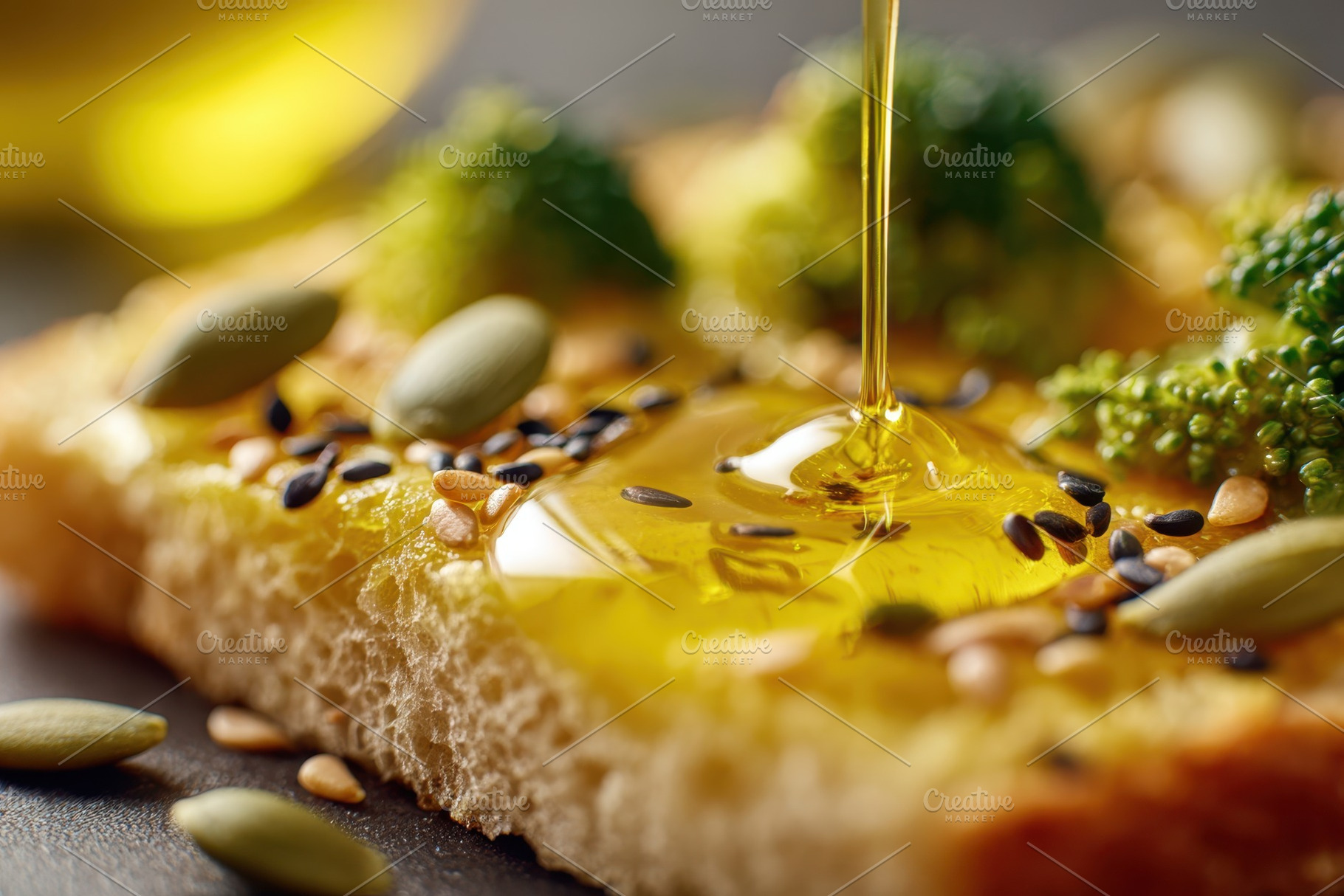 Drizzling olive oil on healthy bread with broccoli and seeds, a Food & Drink Photo by AlyaAnd