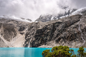 Laguna 69 with turquoise water and snowy mountains in Huaraz, Pe, a Photo by GoodGoods