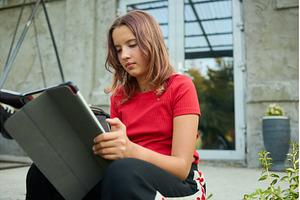 School girl uses tablet while