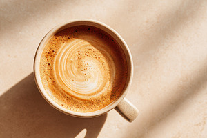 Artistic latte coffee in a ceramic cup, a Food & Drink Photo by AlyaAnd