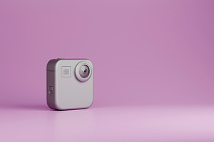 Compact action camera on purple background with copy space, a Technology Photo by RF Images