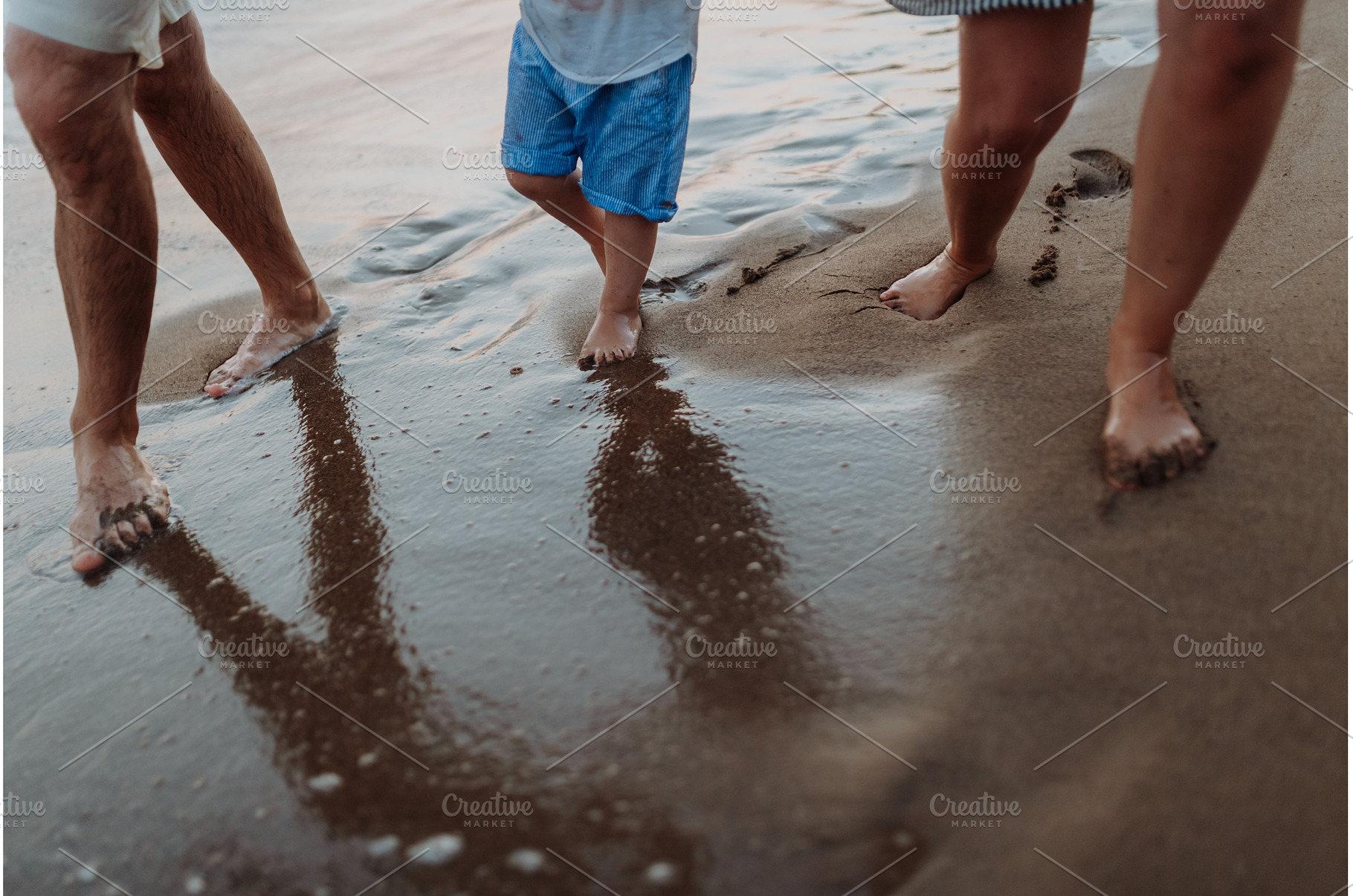 Legs and feet of family standing on, a Person Photo by HalfPoint