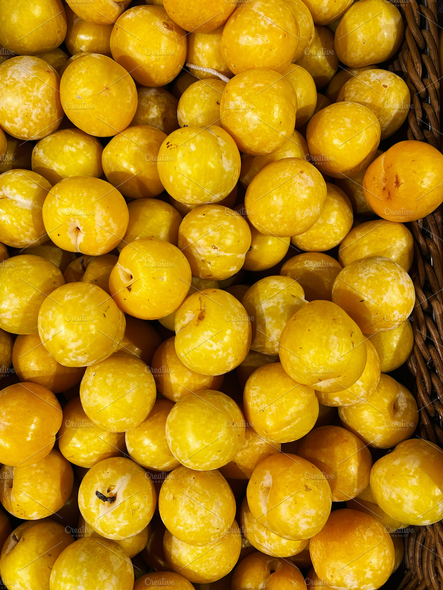 Pile of ripe yellow plums showing their fresh and organic texture, a Photo by AS photostudio