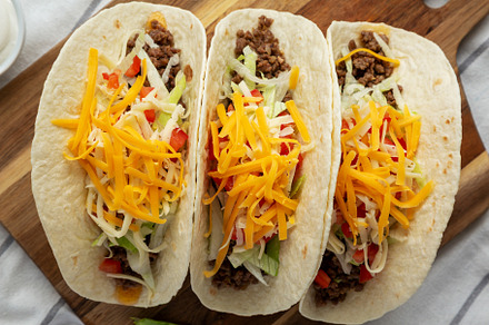 Homemade American Beef Tacos with lettuce, tomato and cheese on, a Food & Drink Photo by LiudmylaChuhunova