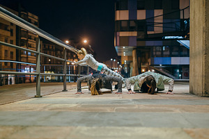 Female sport team doing push ups during training on the city at, a Sports & Recreation Photo by davidpereiras