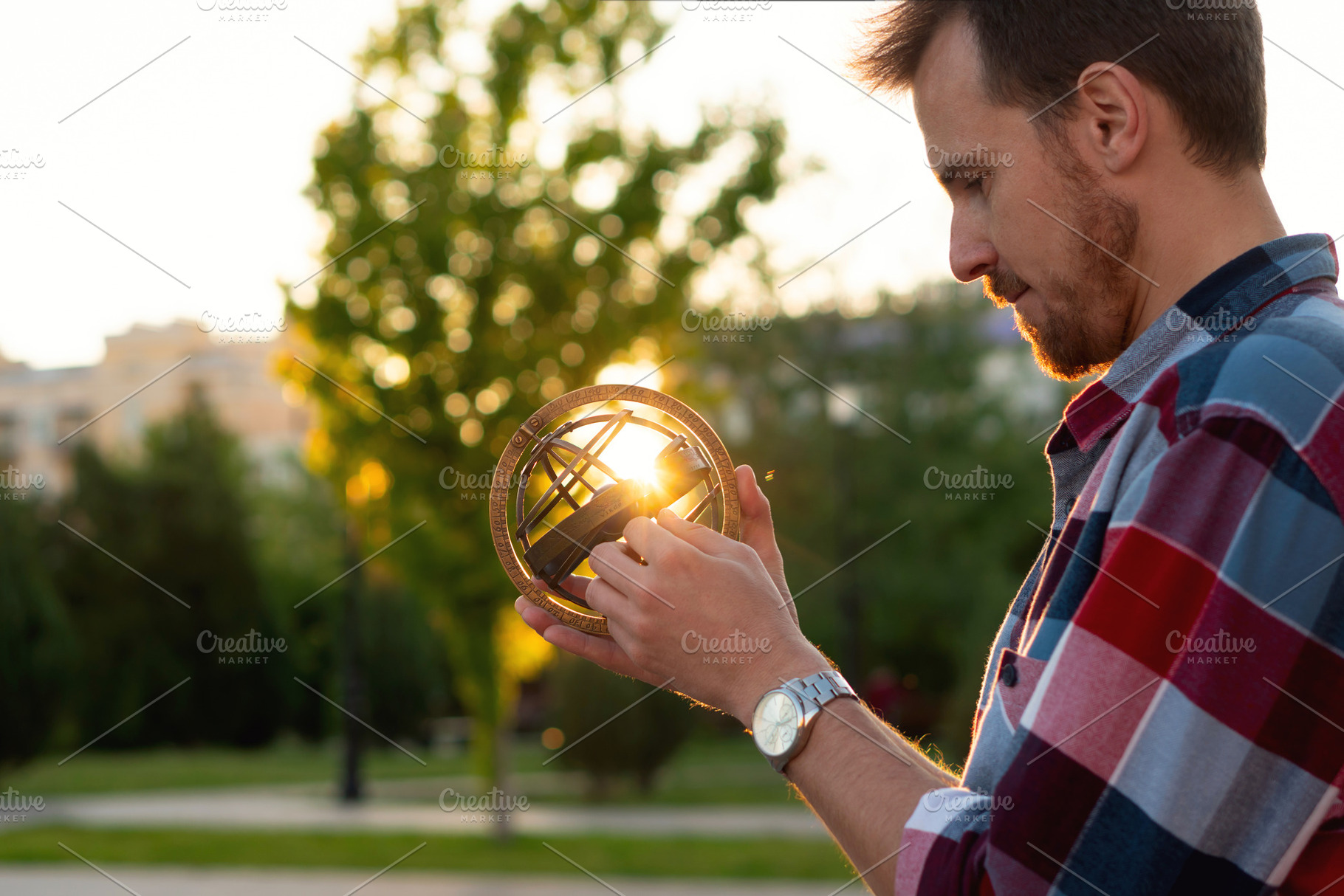 Young man examining vintage globe, a School & Education Photo by Elena Vagengeim