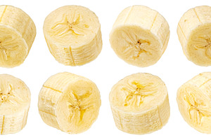 Peeled banana slices isolated, a Photo by Max Lashcheuski