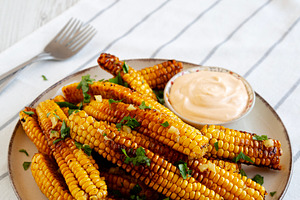 Homemade Spicy Corn Ribs with Mayo on a Plate, side view., a Food & Drink Photo by LiudmylaChuhunova