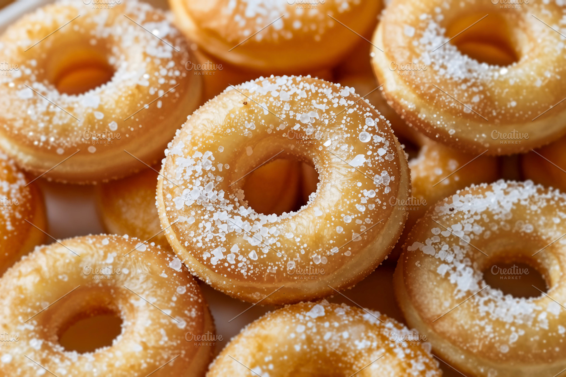 Close-up of Golden Sugar Donuts Pile, a Photo by rarrarorro