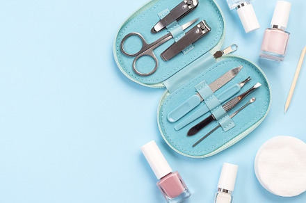 Manicure or pedicure set equipment with nail coat or polish, on blue background, a Beauty & Fashion Photo by iuliia_n