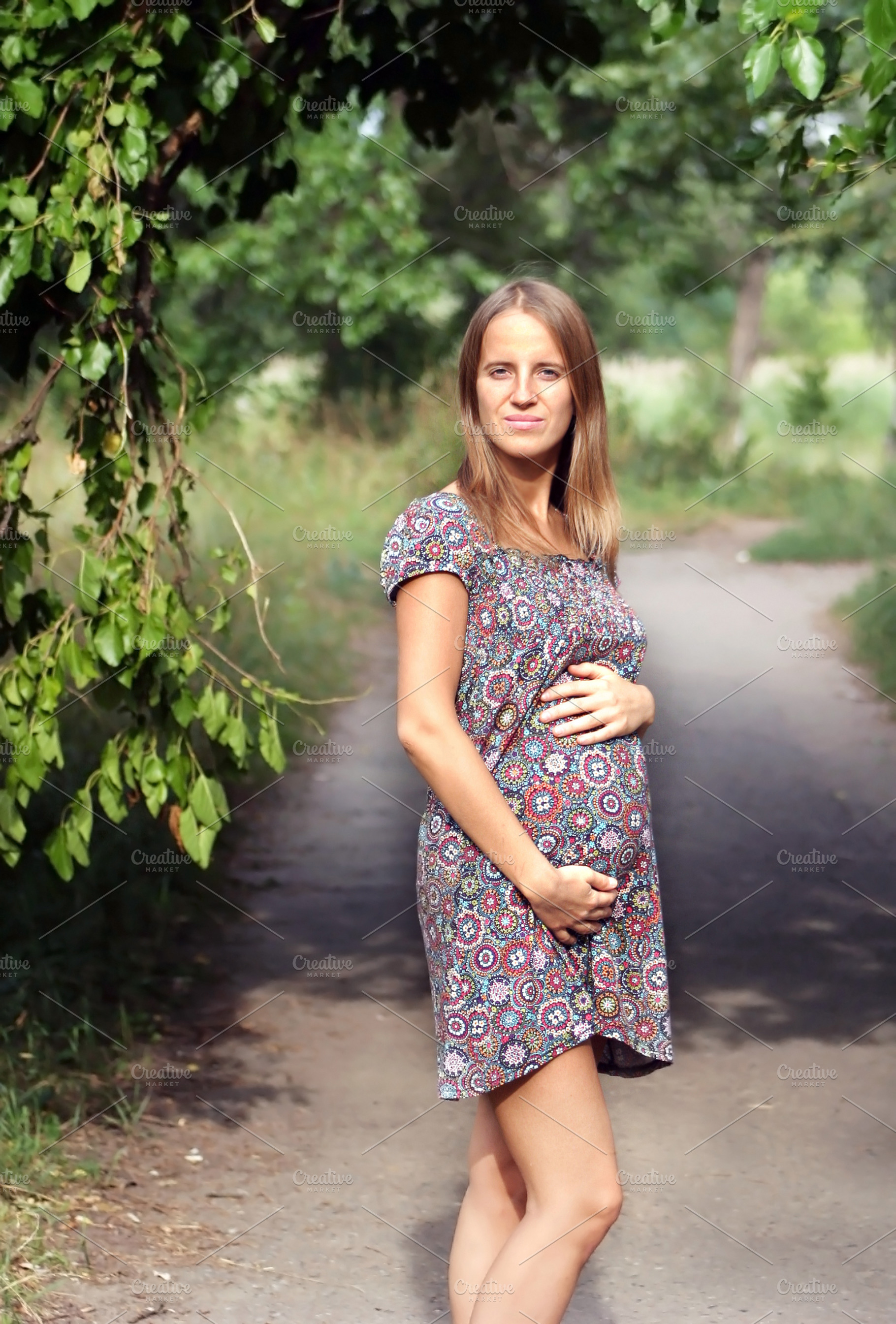 pregnant woman in the park, a Photo by saiko3p