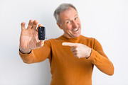 Excited Man Holding Car Key And Pointing, White Background, a Photo by Prostock-Studio (Thumbnail 1 of 2)