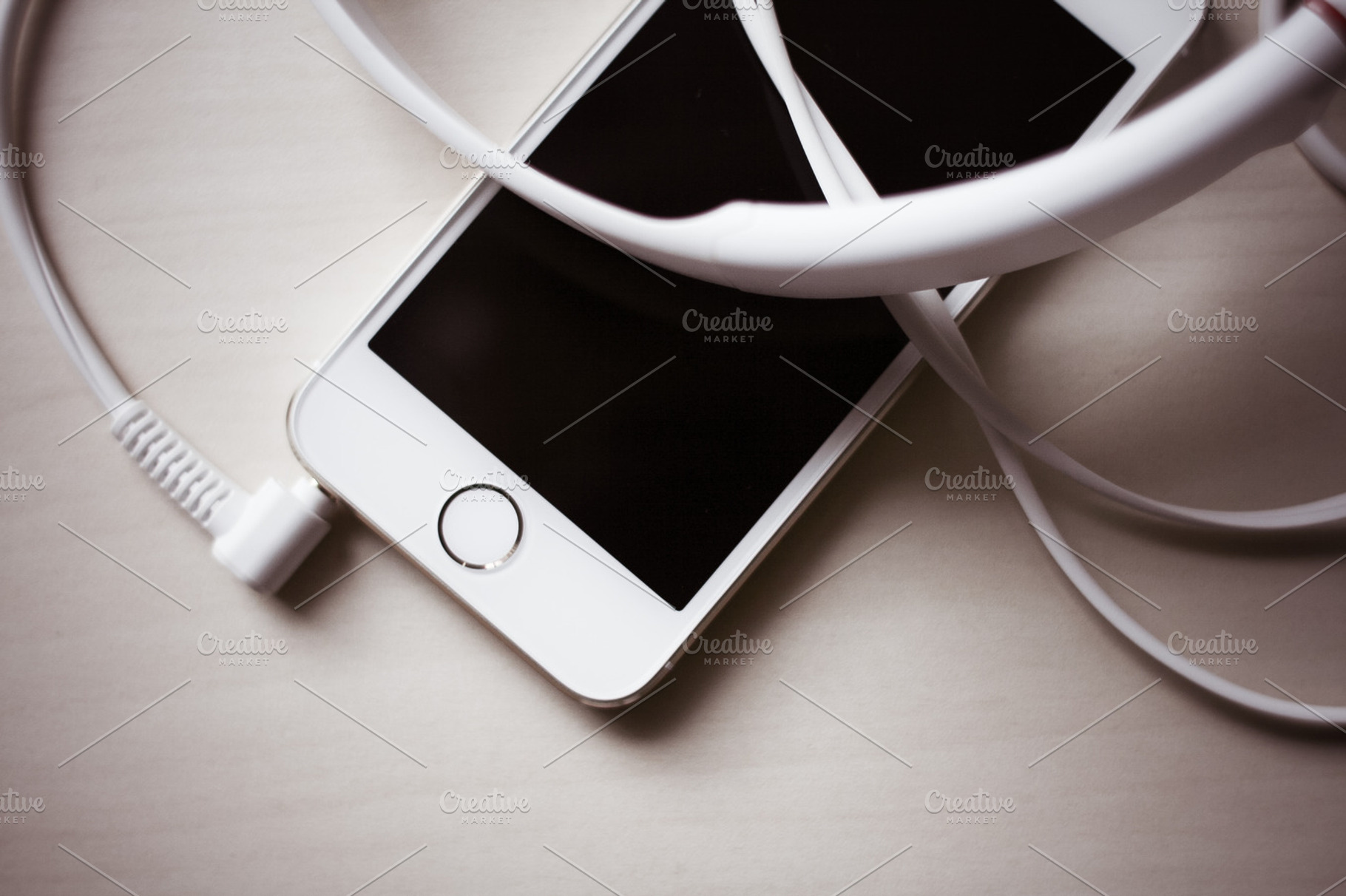 Iphone headphones 1 featuring iphone, desk, and headphones