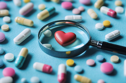 Magnifying Glass Over Heart Symbol Surrounded by Various Pills, an Abstract Photo by Natalia Klenova's Shop