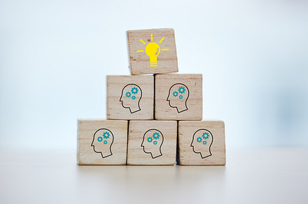Building blocks, teamwork or brainstorming lightbulb idea on isolated background, mock up or office desk mockup. Zoom, wood or cube in cog head innovation for company thinking or unity growth success, a Photo by Peopleimages.com